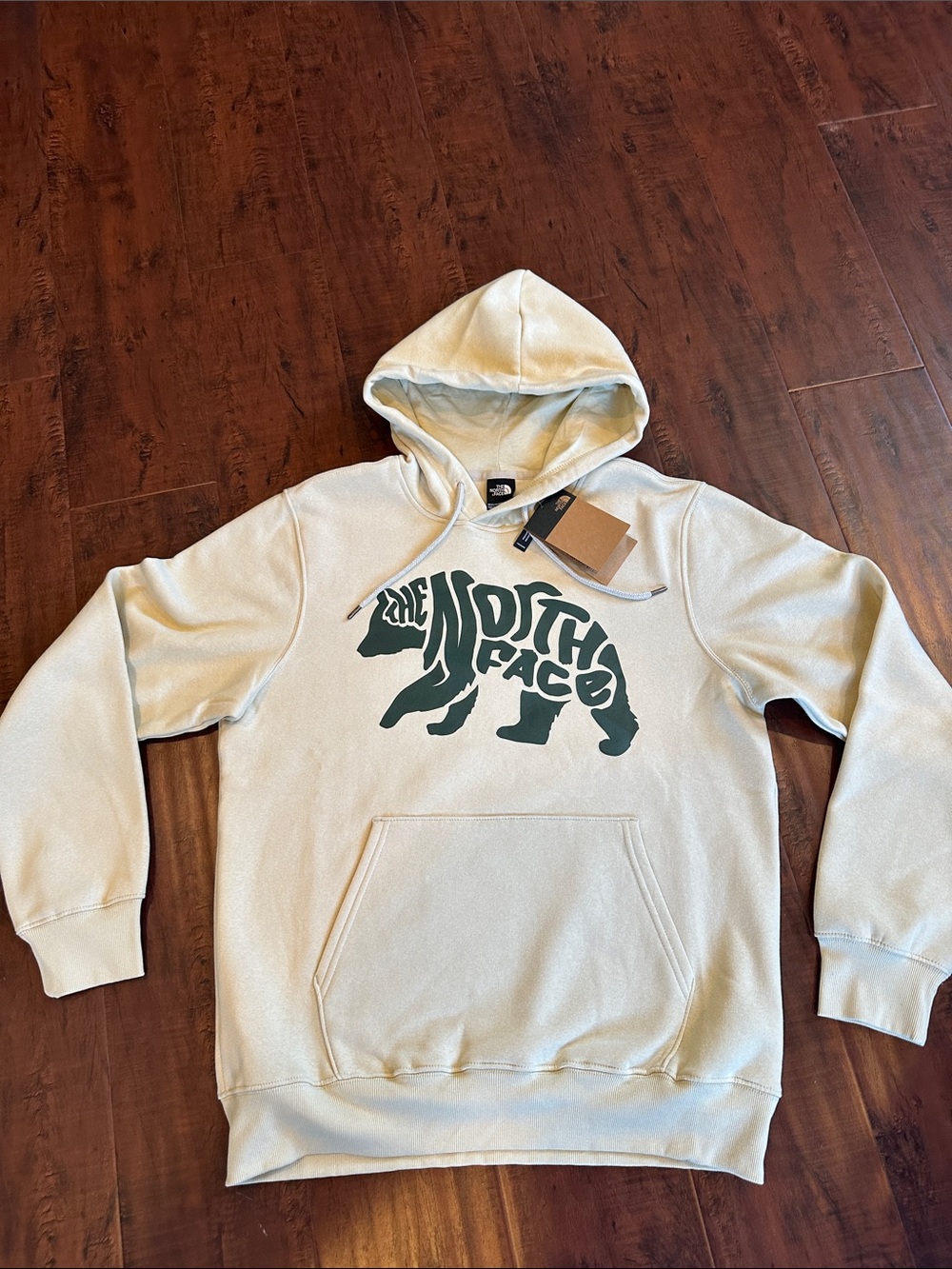 The North Face Cream Hoodie with Green Bear Logo